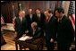 President George W. Bush signs S. 150, The Internet Tax Nondiscrimination Act, in the Eisenhower Executive Office Building Friday, Dec. 3, 2004. Watching the signing are, from left: Congressman Chris Cox, R-Calif.; John Snow, Secretary of the Treasury; Senator Ron Wyden, D-Ore.; Senator George Allen, R-Va.; Don Evans, Secretary of Commerce; Senator John Sununu, R-N.H.; Congressman Mel Watt, D-N.C. White House photo by Tina Hager