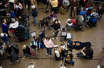 Travelers wait in line for their flights at the Seattle-Tacoma International Airport Dec. 22, in Seattle, Washington.