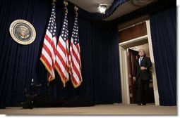 President George W. Bush arrives at a press conference in room 450 of the Eisenhower Executive Office Building on December 20, 2004.  White House photo by Paul Morse