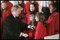 President George W. Bush greets members of the West Tennessee Youth Chorus during the National Christmas Tree lighting ceremony on the Ellipse in front of the White House Dec. 2, 2004. White House photo by Paul Morse.