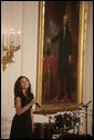 Singer Karina Pasian stands before a portrait of George Washington as she performs for President George W. Bush and guests Friday, June 22, 2007 in the East Room of the White House, in celebration of Black Music Month. White House photo by Debra Gulbas