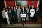 President George W. Bush stands with members of the Pepperdine University Men's Tennis 2006 Championship Team Monday, June 18, 2007 at the White House, during a photo opportunity with the 2006 and 2007 NCAA Sports Champions. White House photo by Eric Draper