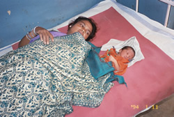 Mother and baby in a hospital bed