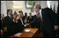 President George W. Bush reaches out to shake the hands of Jose Maria Aznar, left, former Prime Minister of Spain, and Natan Sharansky, Chairman of the Adelson Institute for Strategic Studies at the Shalem Center, after speaking Tuesday, June 5, 2007, to democracy advocates in Prague. White House photo by Eric Draper