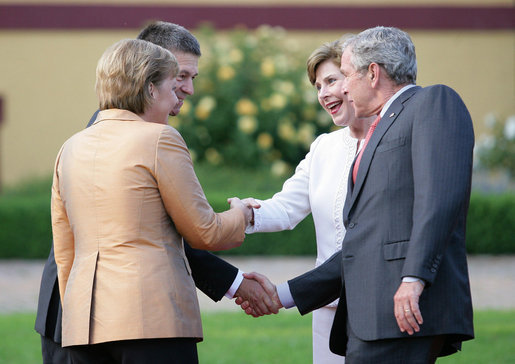 President George W. Bush and Mrs. Laura Bush are greeted by Germany's Chancellor Angela Merkel and her husband, Dr. Joachim Sauer, upon their arrival Wednesday, June 6, 2007, at Hohen Luckow Estate in Hohen Luckow, Germany, for the dinner with G8 leaders and spouses. White House photo by Eric Draper