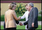 President George W. Bush and Mrs. Laura Bush are greeted by Germany's Chancellor Angela Merkel and her husband, Dr. Joachim Sauer, upon their arrival Wednesday, June 6, 2007, at Hohen Luckow Estate in Hohen Luckow, Germany, for the dinner with G8 leaders and spouses. White House photo by Eric Draper