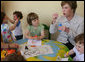 Mrs. Laura Bush blows bubbles for youngsters at the Bethany House Orphanage Sunday, June 10, 2007, in Tirana, Albania. The orphanage is overseen by Bethany Christian Services in Michigan, and has been active in Albania since 1991. White House photo by Shealah Craighead