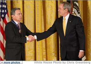 President George W. Bush congratulates President Alvaro Uribe of Colombia after presenting him with the 2009 Presidential Medal of Freedom Tuesday, Jan. 13, 2009, during ceremonies in the East Room of the White House. White House photo by Chris Greenberg