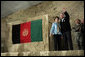 President George W. Bush and Laura Bush wave to an audience of U.S. and Coalition troops, Wednesday, March 1, 2006, upon their arrival to Bagram Air Base in Afghanistan. White House photo by Eric Draper