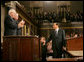 Italian Prime Minister Silvio Berlusconi smiles at Vice President Dick Cheney and House Speaker J. Dennis Hastert, as he gestures in response to a warm welcome given by members of a joint session of Congress, Wednesday, March 1, 2006. White House photo by David Bohrer