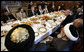 President George W. Bush and President Hamid Karzai of Afghanistan share a working lunch Wednesday, March 1, 2006, at the Presidential Palace in Kabul during a stop by President Bush en route to India. White House photo by Eric Draper