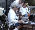 Photo of Kunz and his colleagues setting up an infrared camera to census bat populations.