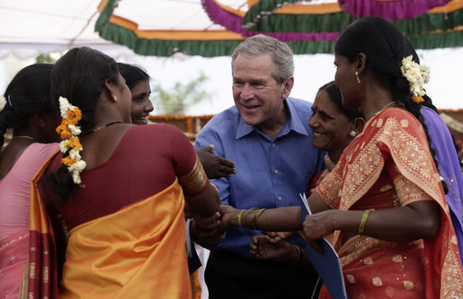 President George W. Bush is surrounded by fans as they pose for photos Friday, March 3, 2006, at the Acharya N.G. Ranga Agriculture University in Hyderabad, India. White House photo by Eric Draper