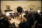 President George W. Bush and Peru's President Alejandro Toledo talk with reporters during their Oval Office visit, Friday, March 10, 2006 at the White House. White House photo by Eric Draper