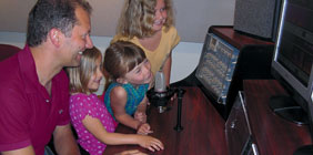 Kids and an adult in front of a monitor