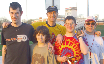 Scott Otterbein with three of his young Special Olympics athletes and field event coach, Vince Flocco.