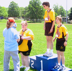 Mary Walsh, Kathy Prosperi and Otterbein's daughter Lauren receiving awards at county track meet.