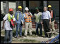 President George W. Bush talks with workers cleaning up the hurricane ravaged neighborhood of the lower 9th Ward of New Orleans, Wednesday, March 8, 2006, during a tour of New Orleans neighborhoods. White House photo by Eric Draper