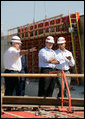 President George W. Bush and New Orleans Mayor Ray Nagin, right, view flood wall construction in the Industrial Levee Canal, Wednesday, March 8, 2006 in New Orleans, during a tour to view the clean up and reconstruction progress of New Orleans six-months after the city was devastated by Hurricane Katrina. White House photo by Eric Draper