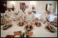 White House Executive Pastry Chef Thaddeus DuBois, center-background, supervises his staff, Tuesday, March 21, 2006, as they prepare the dessert trays for the social luncheon in honor of Liberia's President Ellen Johnson Sirleaf at the White House. White House photo by Paul Morse