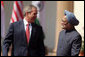 President George W. Bush smiles as he stands with India's Prime Minister Manmohan Singh during a press availability in New Delhi Thursday, March 2, 2006. The President told those in attendance that India and America "have built a strategic partnership based on common values," and thanked the Indian people and the Indian government "for supporting the new democracy in the neighborhood." White House photo by Paul Morse