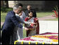 President George W. Bush and Laura Bush sprinkle flowers on the south side of the Mahatma Gandhi Memorial Thursday, March 2, 2006, during a wreath-laying ceremony in Rajghat, India. White House photo by Eric Draper