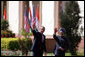 President George W. Bush and Prime Minister Manmohan Singh of India wave as they leave Mughal Garden at the Hyderabad House after a press availability in New Delhi Thursday, March 2, 2006. White House photo by Paul Morse