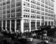 Exterior of a department store building with crowds on the sidewalk