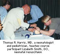 Thomas R. Harris, MD, a neonatologist and pediatrician, teaches course participant Lizbeth Smith, DO, neonatal resuscitation