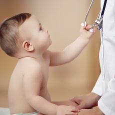 Photograph of a baby grabbing a doctor's stethoscope