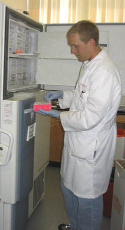 Aaron Baker, Lab Manager, readies DNA samples for storage.