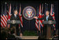 President George W. Bush responds to a question during a joint news conference with British Prime Minister Tony Blair, Thursday, Dec. 7, 2006, in the Dwight D. Eisenhower Executive Office Building. 