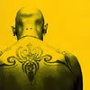 Stylized photo of the upper back of a man with a large, complicated tattoo