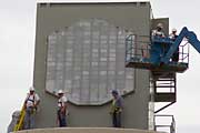 Workers install the phased array radar antenna during construction of the National Weather Radar Testbed.