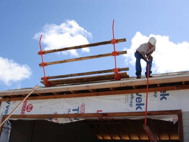 The NIOSH-designed roof bracket-safety rail assembly being installed on a residential work site for fall-prevention purposes