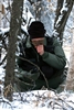 U.S. Air Force 1st Lt. Matthew Feeman stops and rests while trying to warm up his hands in below freezing conditions as he navigates through the woods to a safe location for extraction during RED FLAG-Alaska 09-1 on Eielson Air Force Base, Alaska, Oct. 14,. 2008. 