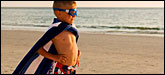 A boy playing superhero with a towel for a cape. Photo: iStockphoto