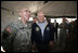 Vice President Dick Cheney has lunch with US and Iraqi troops at the 9th Mechanized Infantry Division Headquarters, a training facility for Iraqi troops, Sunday Dec 18, 2005.