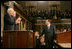 Italian Prime Minister Silvio Berlusconi smiles at Vice President Dick Cheney and House Speaker J. Dennis Hastert, as he gestures in response to a warm welcome given by members of a joint session of Congress, Wednesday, March 1, 2006.