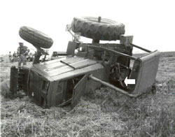 overturned tractor -- arrow indicates the victim's location
