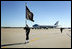 A Naval honor guard carries the Presidential Colors on the tarmac of Andrews Air Force Base, Md., as the plane carrying the body of former President Gerald R. Ford prepares to depart for Grand Rapids, Mich., Tuesday, January 2, 2007, following the former president's State Funeral in Washington, D.C.