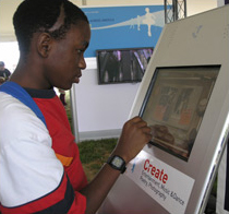 National Book Festival visitors such as Maximillien Kamdcen enjoy the many electronic exhibits that brought the Library and its online collections to life in the Library of Congress pavilion