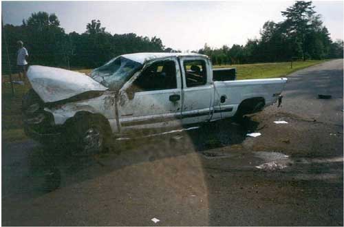 Photo 2. Illustrates damage to the driver’s side of the vehicle.