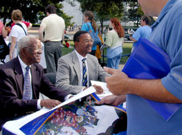 John Hope Franklin and his son, John Whittington Franklin, signed posters and books for readers and fans