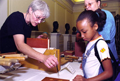 a young visitor gets her name written in calligraphy