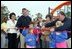 Laura Bush attends a ribbon cutting ceremony with football star Brett Favre and his wife, Deanna, left, Secretary Margaret Spelling, center, Darell Hammond, Associate Director, USA Fredom Corps, right, and student of Hancock North Central Elementary Shool at the Kaboom Playground, built at the Hancock North Central Elementary School in Kiln, Ms., Wednesday, Jan. 26, 2006, during a visit to the area ravaged by Hurricane Katrina.