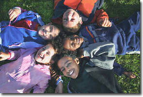 Photo of children lying in the grass