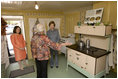 Mrs. Laura Bush receives an explanation of the scale of author Laura Ingalls Wilder's kitchen from Mrs. Jean Coday, Director and President of the Laura Ingalls Wilder Historic Home and Museum in Mansfield, Mo., Oct. 3, 2008. Accompanying the two on the tour is Mrs. Melanie Blunt, First Lady of Missouri. Wilder is one of Mrs. Bush's favorite writers and she was surprised to see the petite kitchen, built to function for the 4-foot-10-inch author.