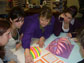 Photo of teacher Diane Schnellhammer working with students on a math project.