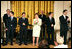 Mrs. Laura Bush stands with members of the cast from the Tony award-winning musical "Jersey Boys" as they perform during a luncheon for Senate Spouses in the East Room, Monday, June 12, 2006. White House photo by Shealah Craighead 